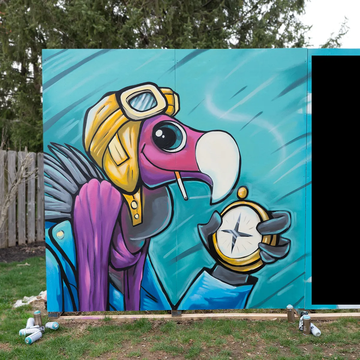 A spray paint mural of a smirking buzzard character